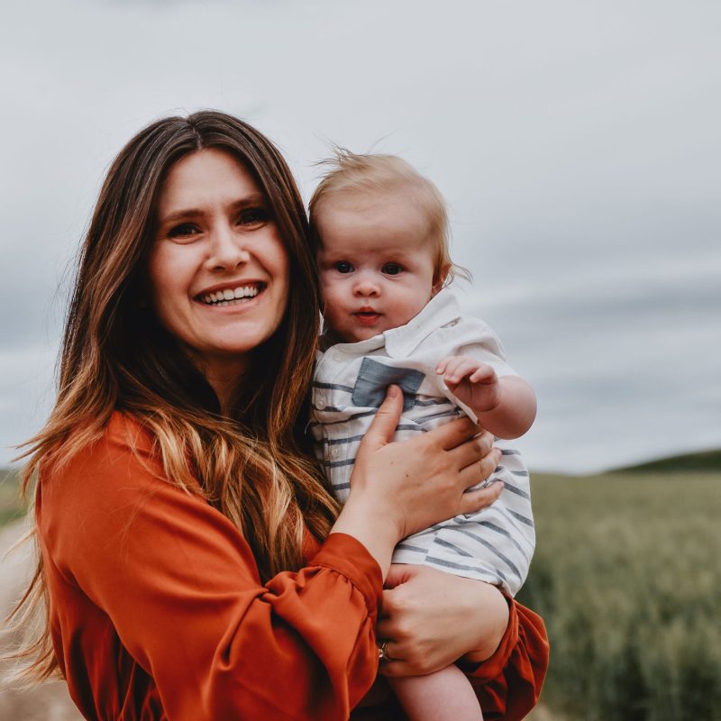 Alma holding her son A new mother going through the postpartum period is holding her son and smiling